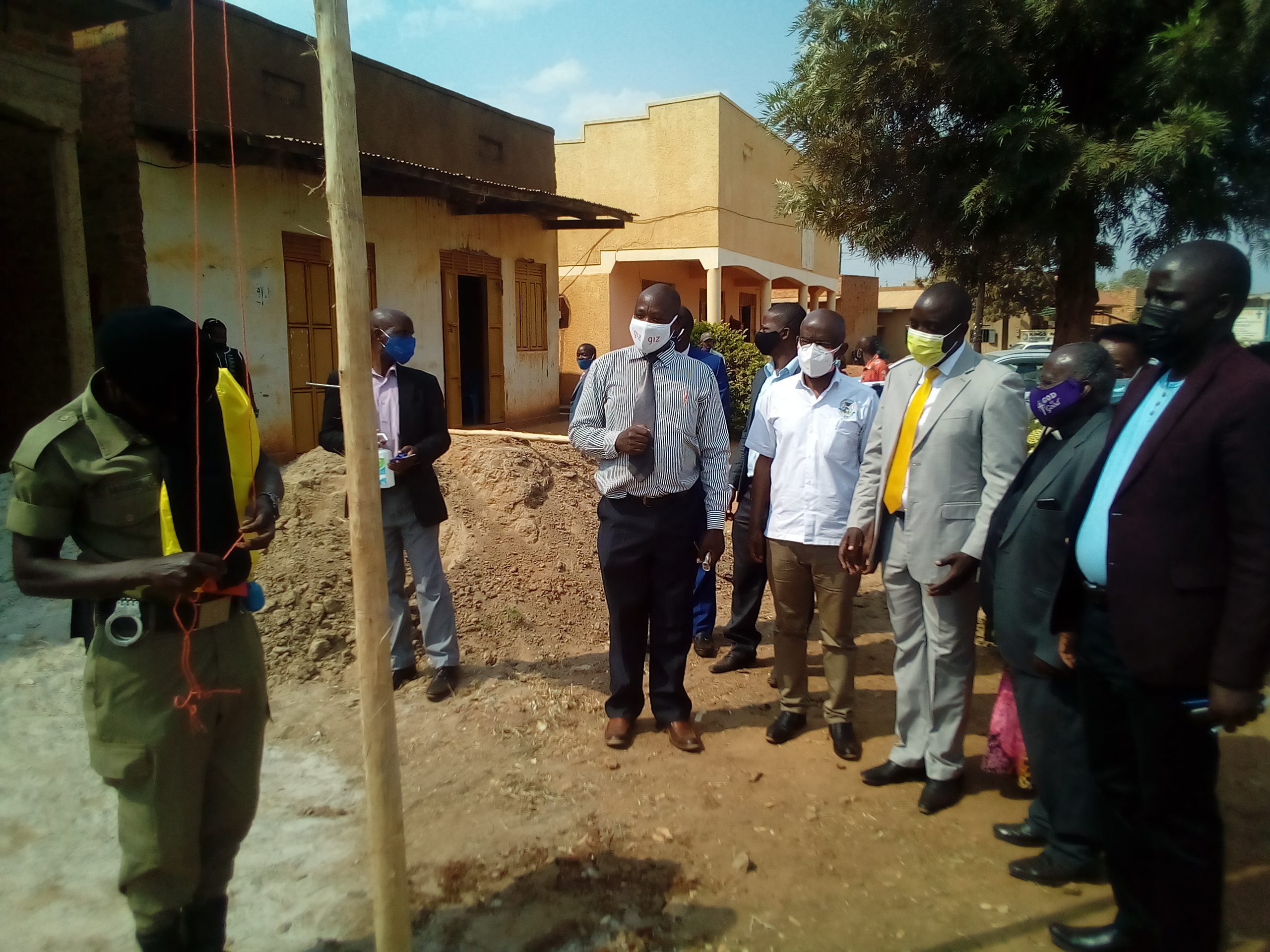 Hon. Kyooma flanked by District Leaders rising the flag to mark the starting of Kanyarugiri Town Council. Photo by Sylas Byaruhanga.jpg
